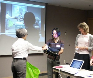 Eagranie wins a door prize from Pam at the September 2008 meeting, with Karen looking on